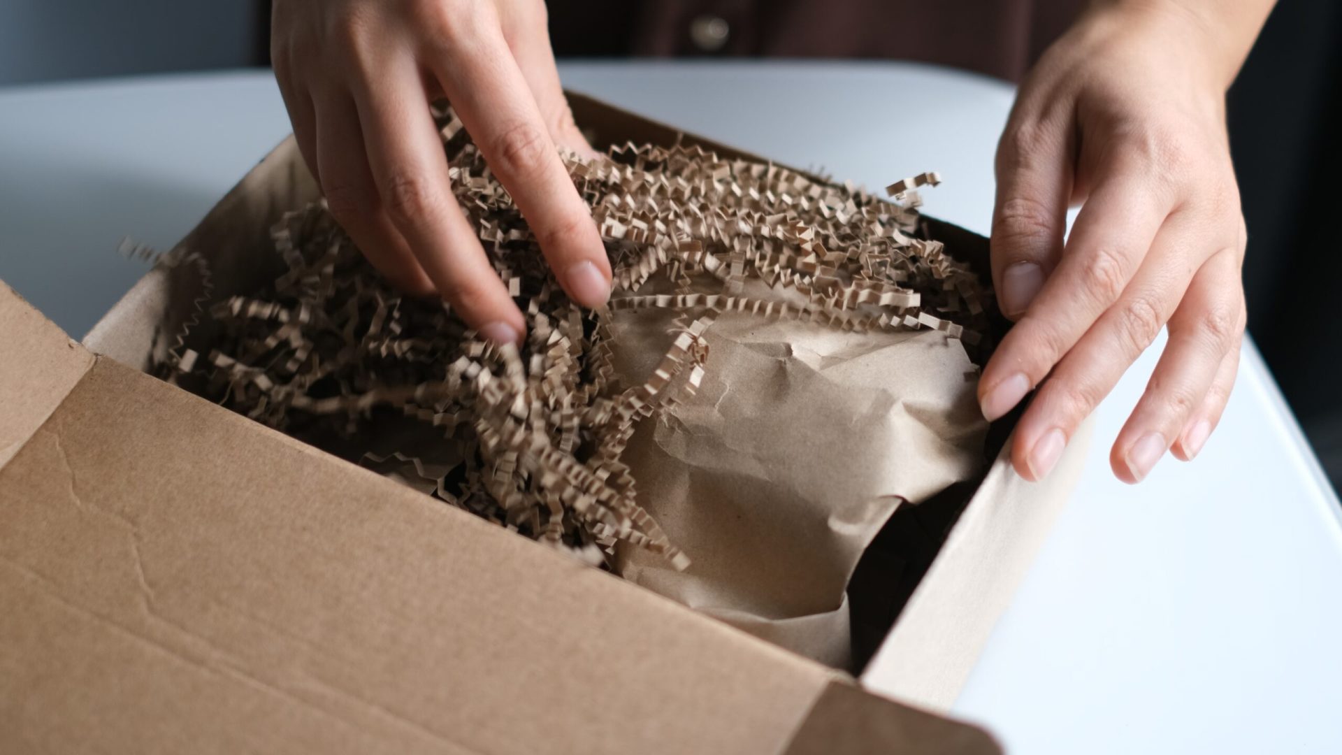 Woman,Opening,Parcel,Indoors.,Woman,Opening,And,Unpacking,Cardboard,Box