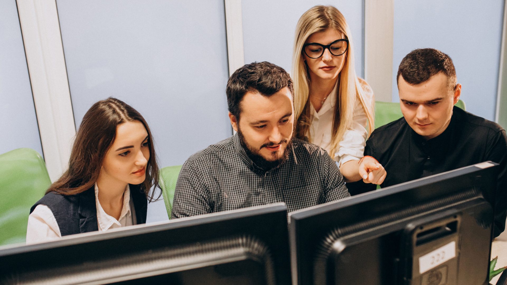 Workers at an IT company working on a computer